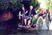 Man an woman with an old car